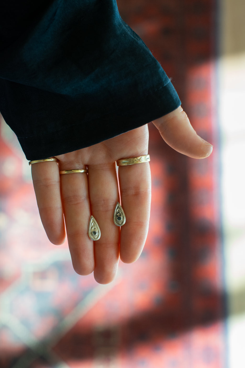  two silver teardrop-shaped earrings set whith blue gemstones